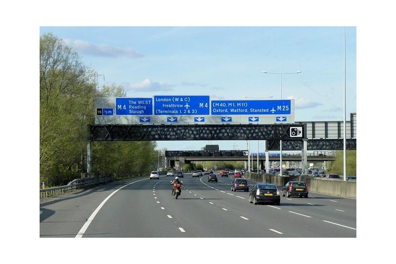 M25 approaching Colnbrook Interchange with cars